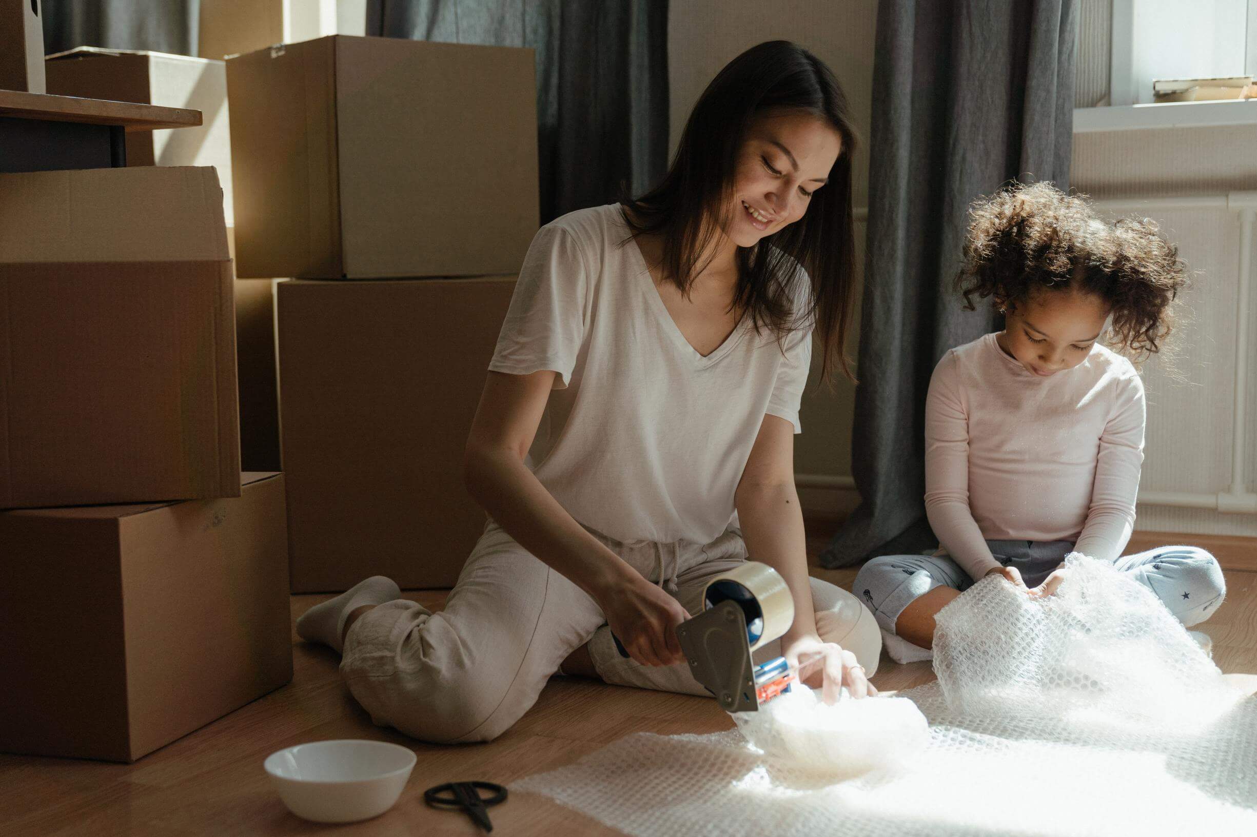 A woman and a child using bubble wrap