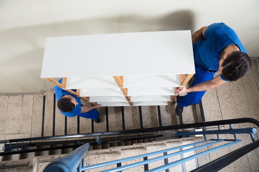 Workers carrying a shelf