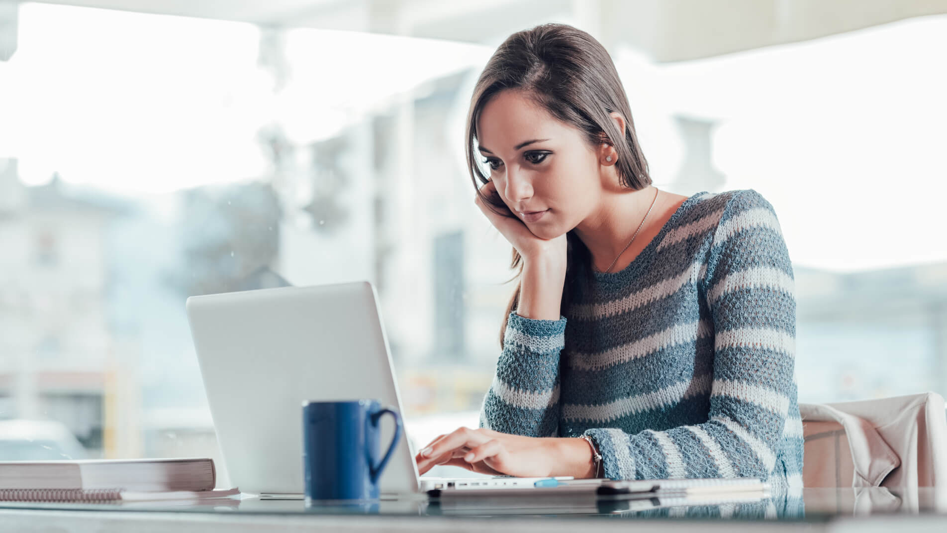 A woman looking at the screen