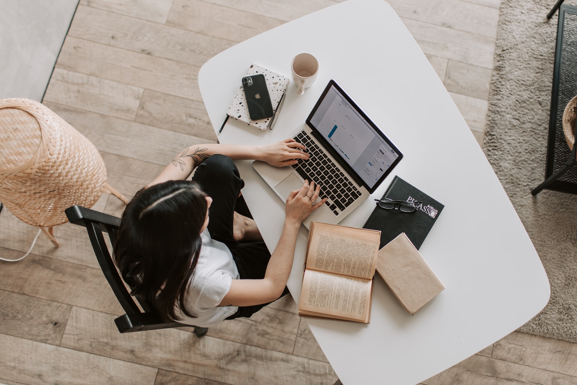 A woman typing on a laptop