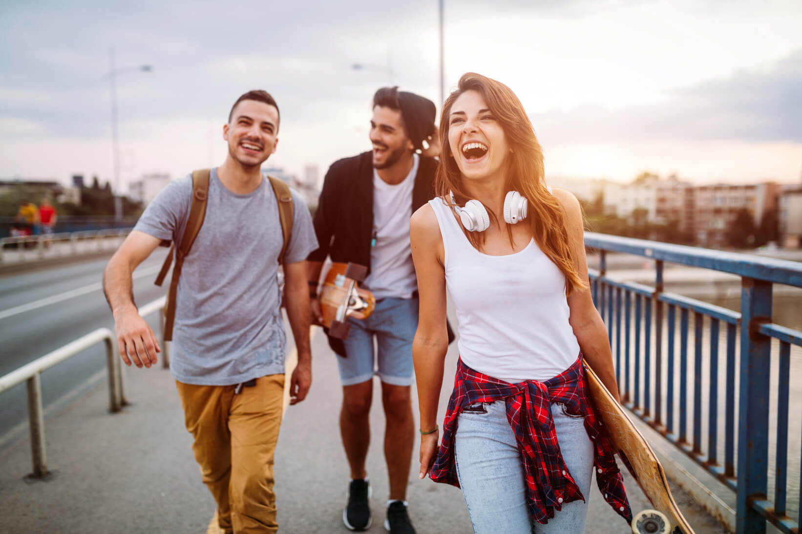 Three people walking and laughing