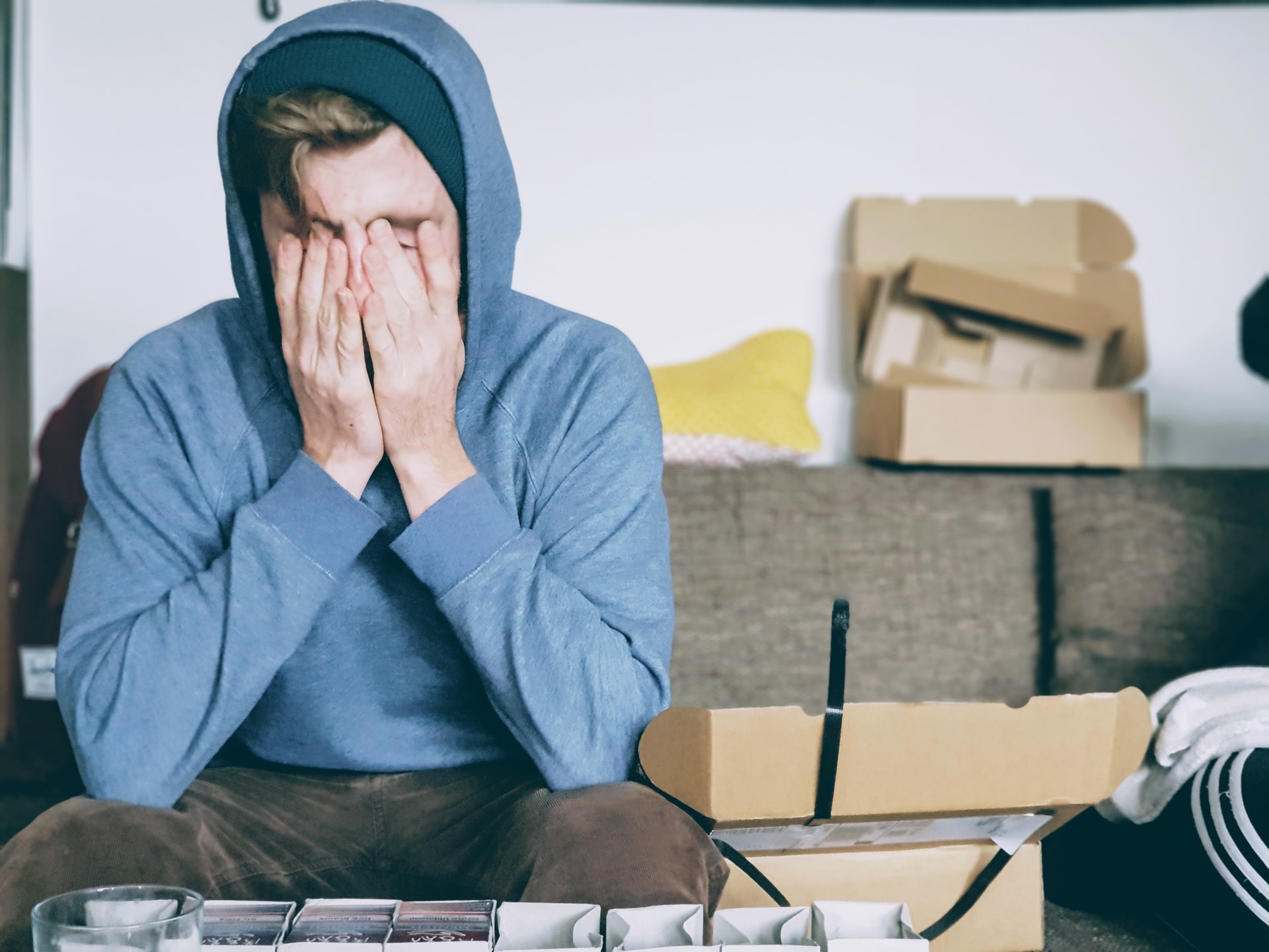 A stressed man surrounded by boxes
