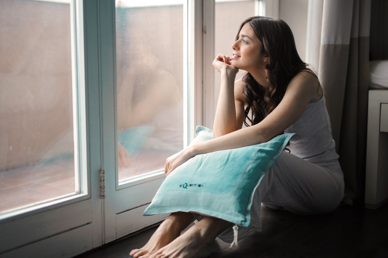 A woman holding a pillow