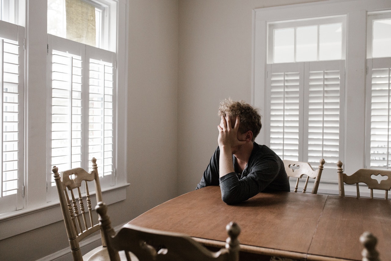 A worried man sitting at the table