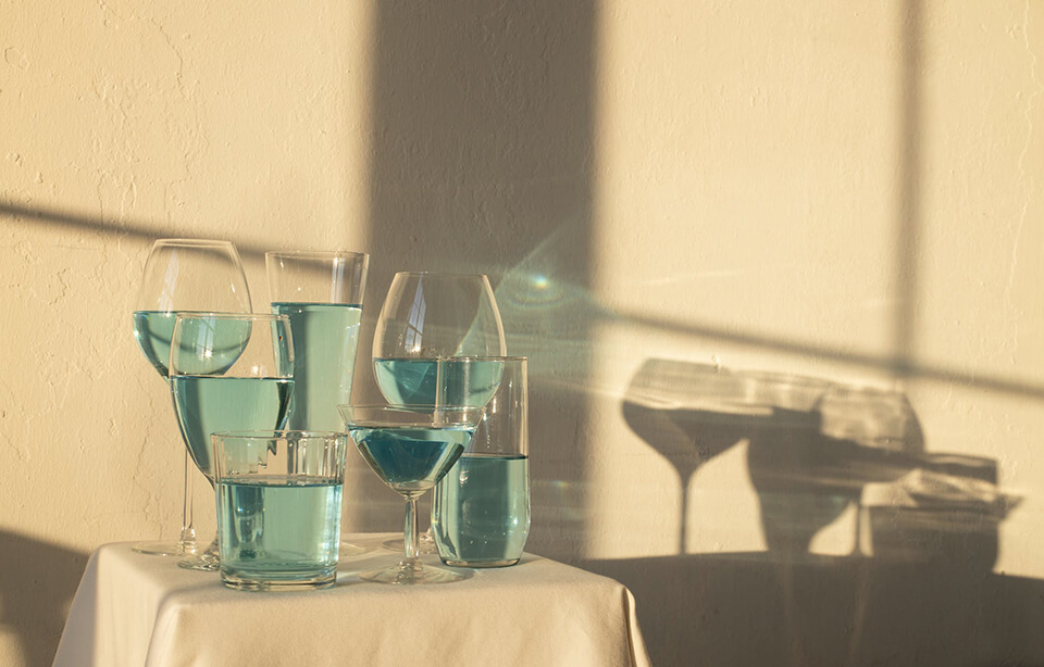 Glassware with blue liquid on a small table