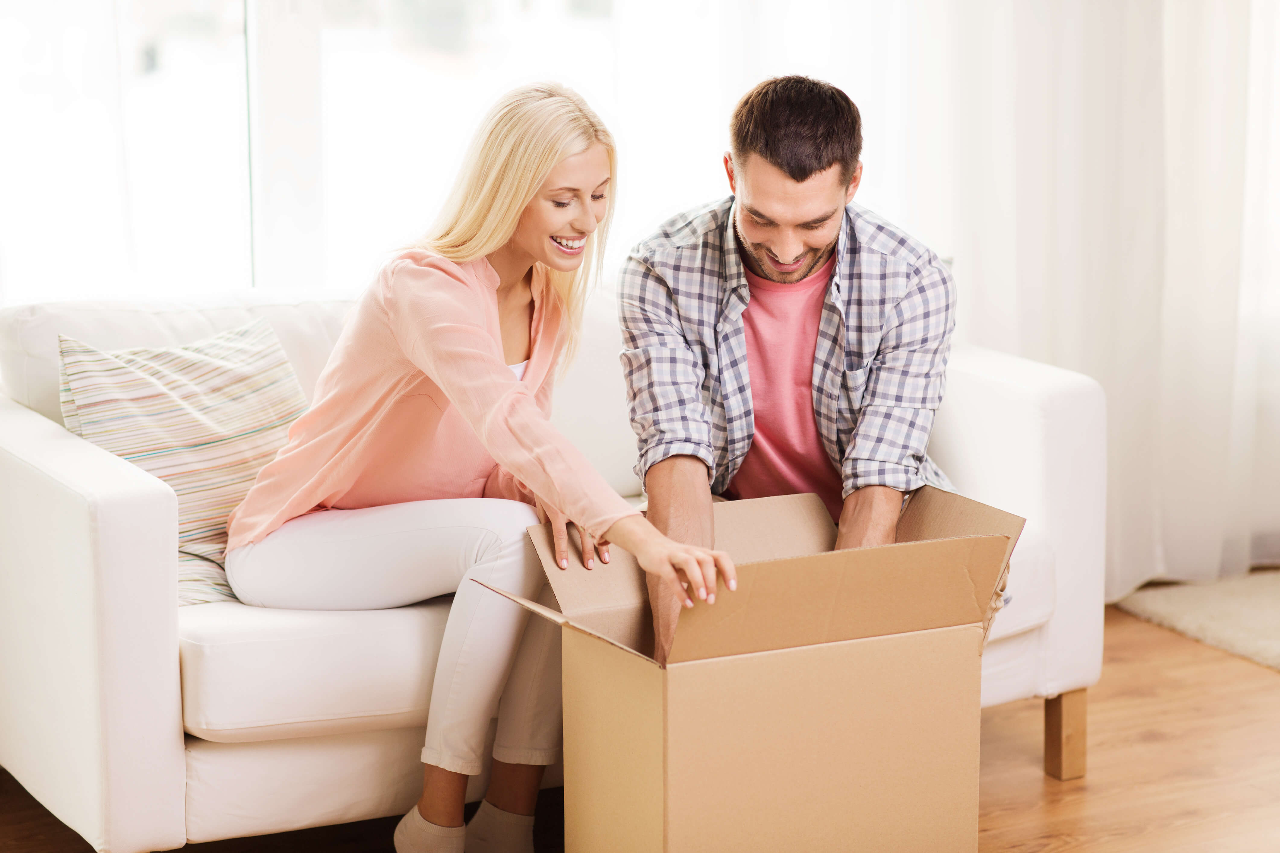 A couple looking at a new box for moving