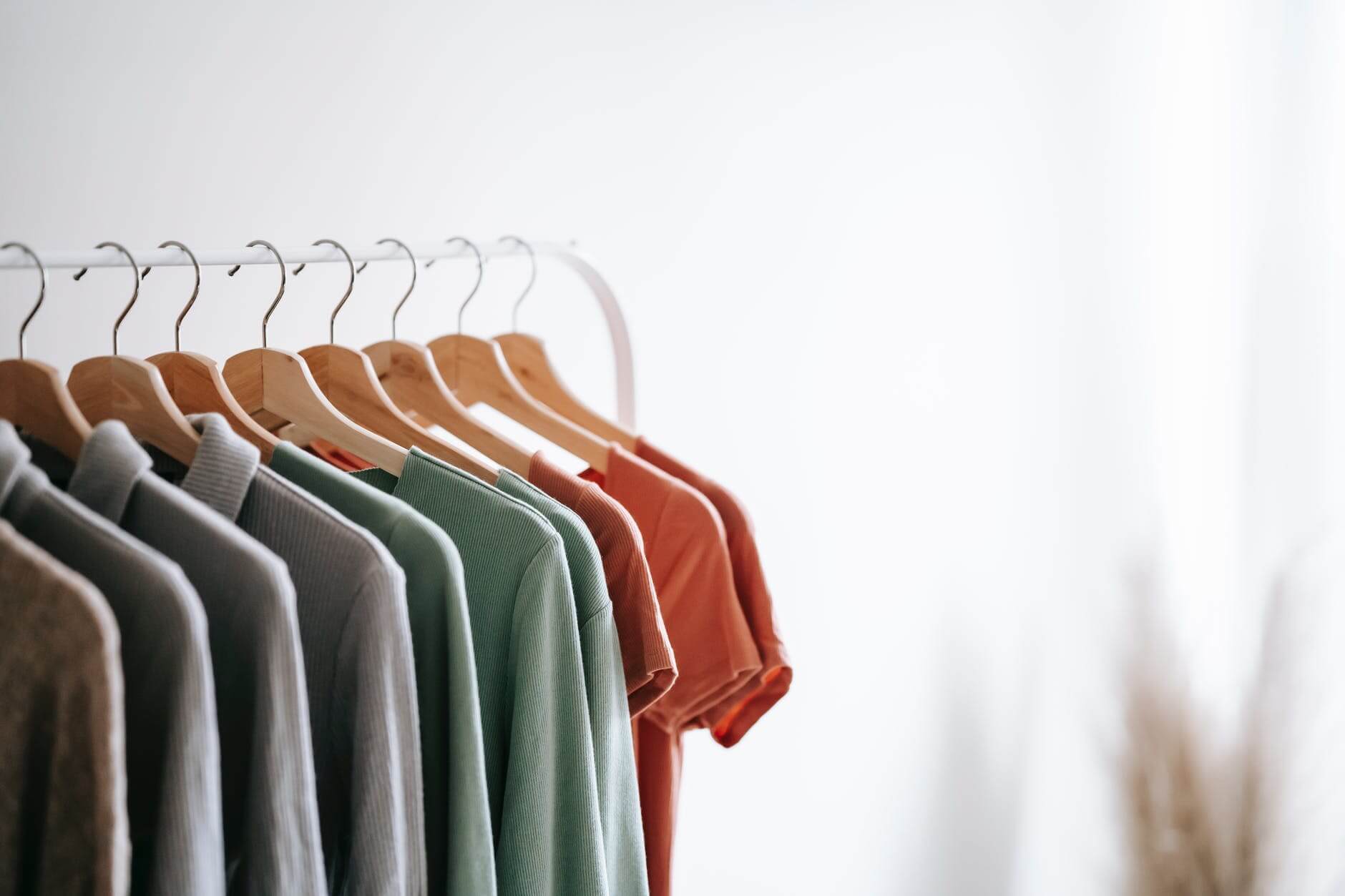 A clothing rack with T-shirts on it