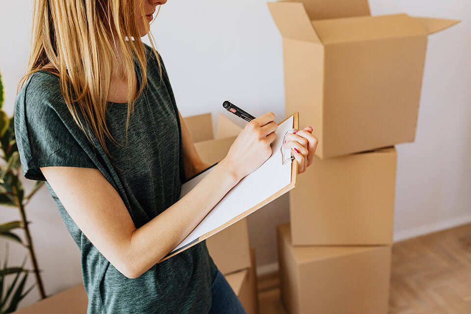 A woman deciding to use a moving app to compare moving companies