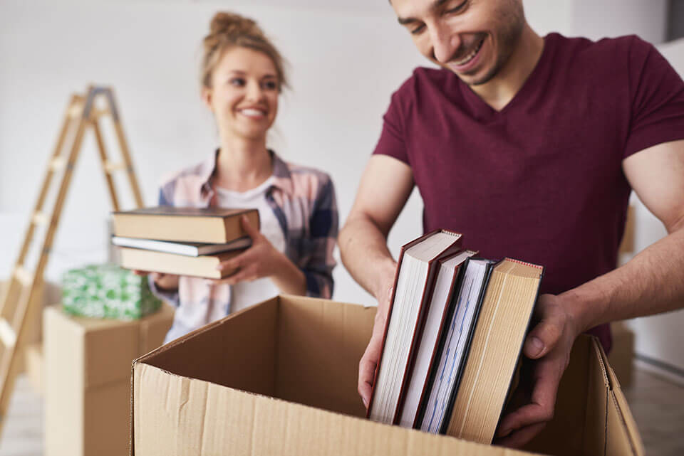 Man and woman putting publications in the package