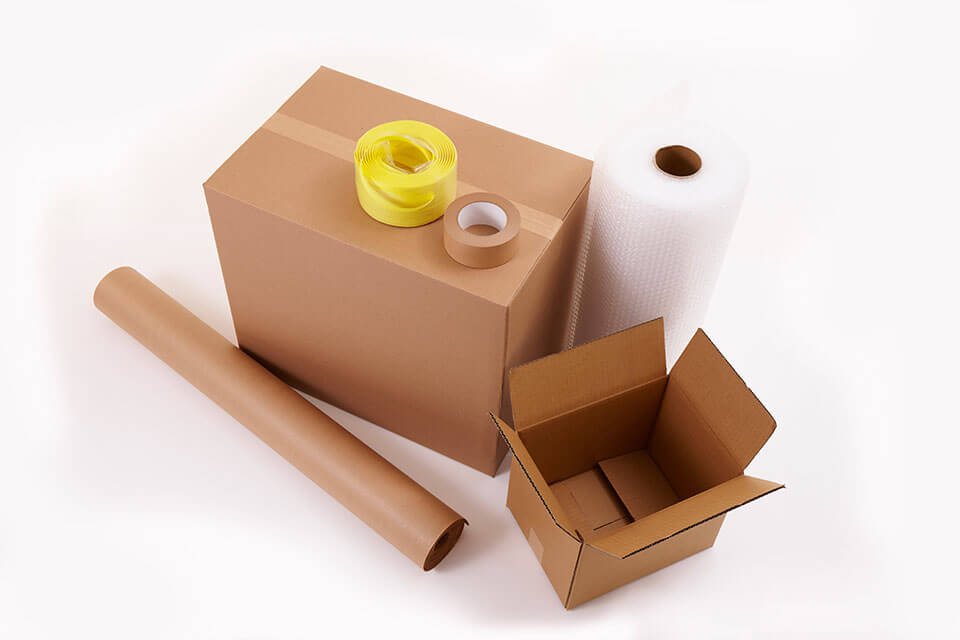 Packages, tape, bubble wrap, and paper roll