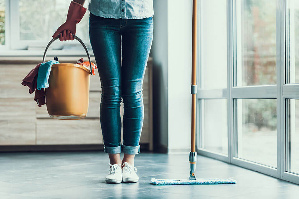 A girl cleaning an apartment before the moving company carries in her items