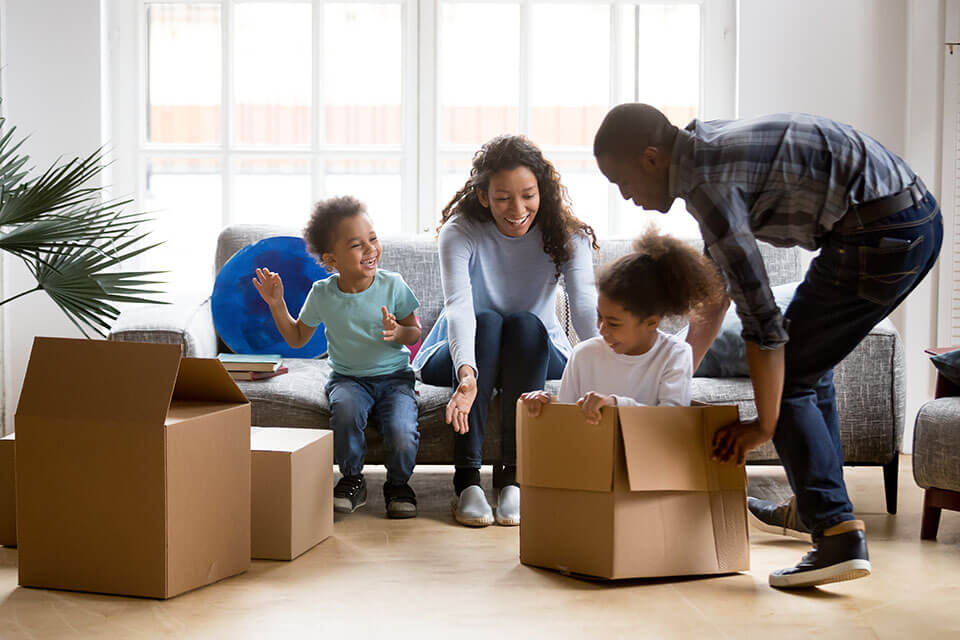 Parents and their children playing and unpacking