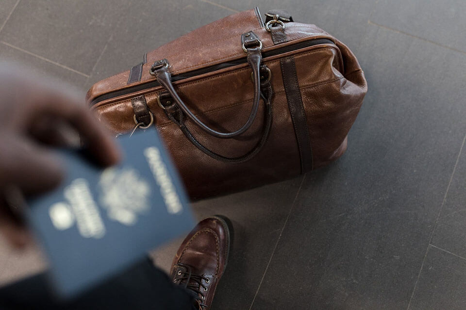 Carryon bag and passport ready for a moving company