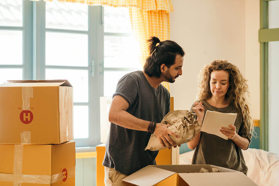 Couple making a list of moving companies