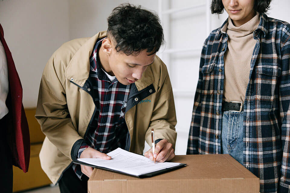 Man signing a contract with a moving company