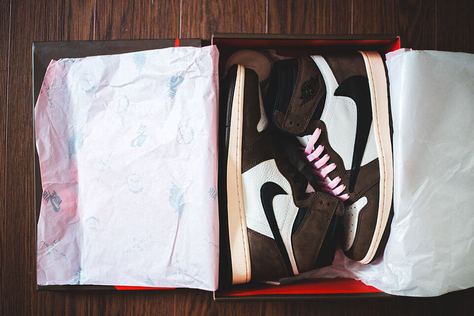 Sneakers packed in a box before searching for an app for moving