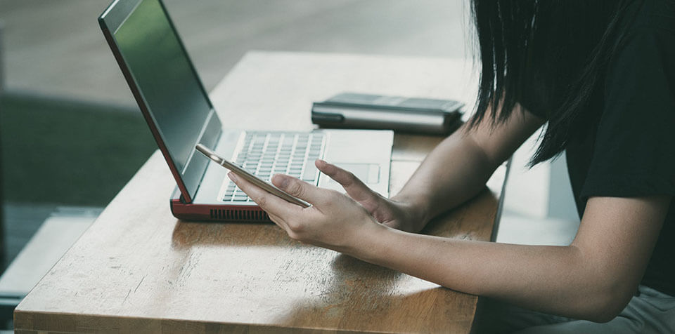 Woman with a laptop calculating the costs on a moving app