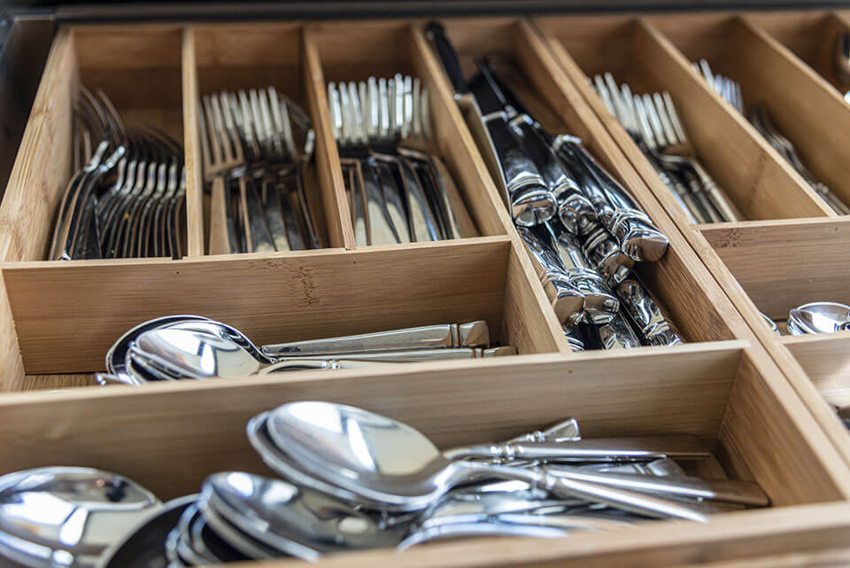 Silver set in a wooden tray ready for relocation with one of the moving companies found on the Mod24 moving app