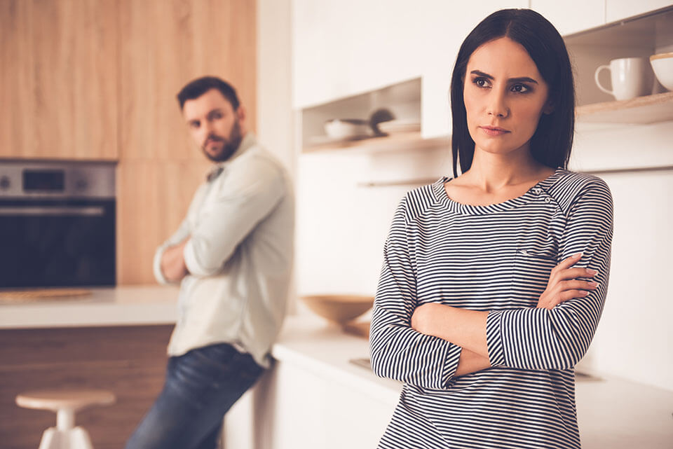 a couple looking angry at each other after a fight