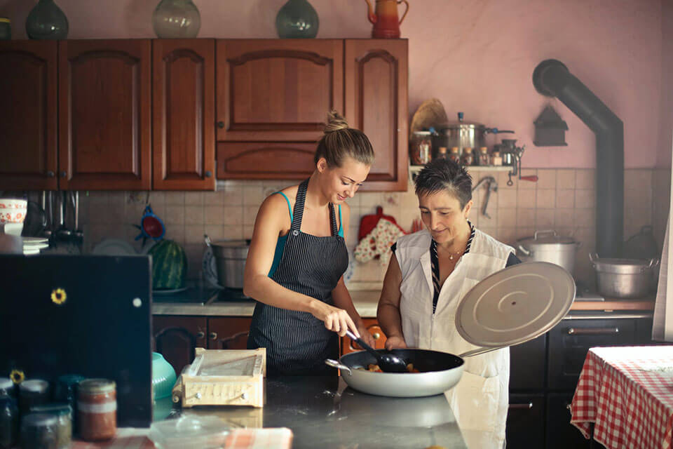 A mom and her daughter cooking a meal