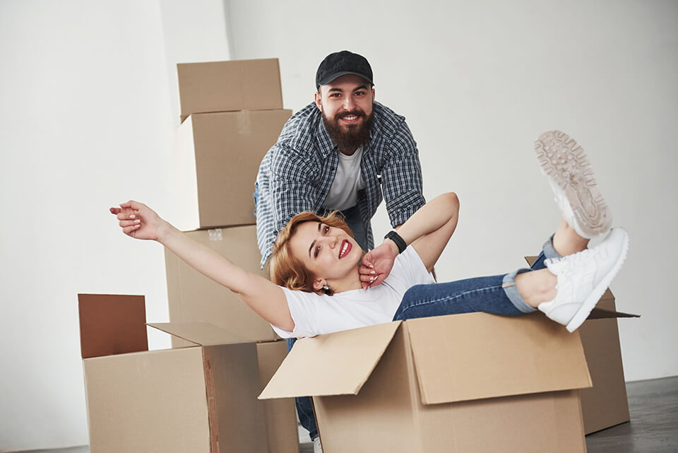 A happy woman sitting in the box, a man behind her