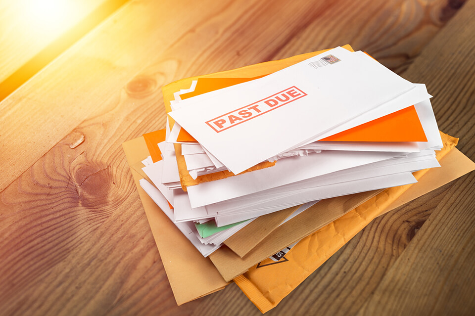 A stack of mail and unpaid bills